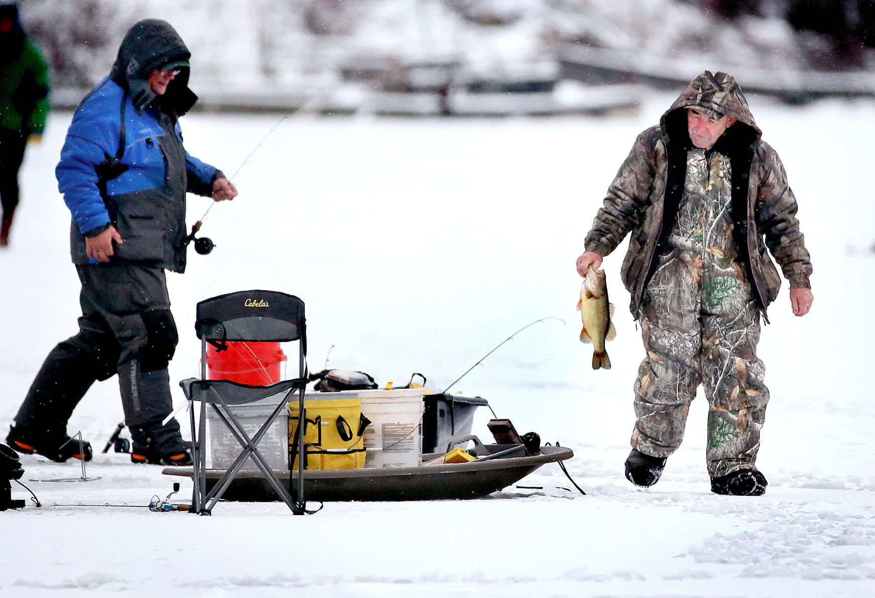 Ice angler with bass